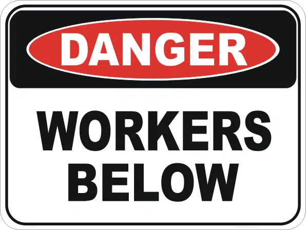 Workers below sign